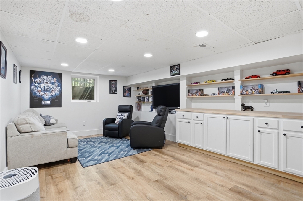 80 Concord Street Maynard, MA 01754 - Photo 20 of 29 a living room with furniture a flat screen tv and white walls