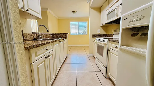 a view of a lake in front of house with outdoor seating