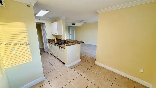 a kitchen with granite countertop a sink and a stove