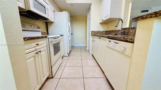 a kitchen with stainless steel appliances a refrigerator and a stove