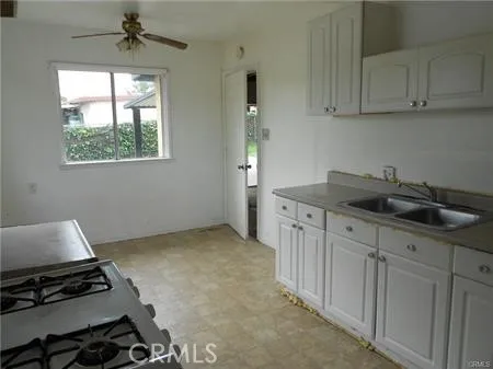a kitchen with sink cabinets and window