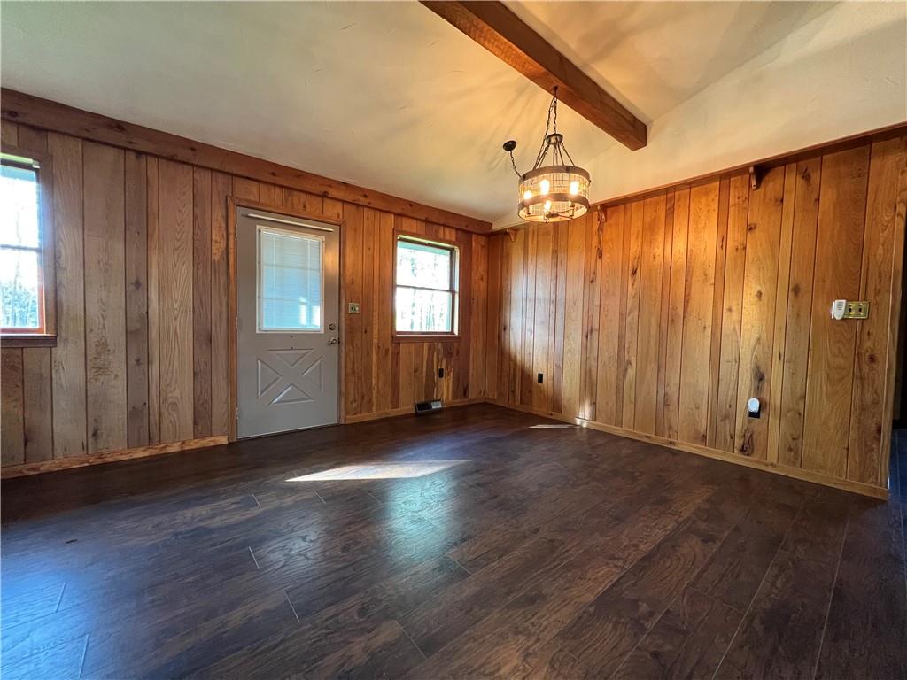 915 Quebec Road Farmington, PA 15437 - Photo 23 of 41 an empty room with wooden floor staircase and windows