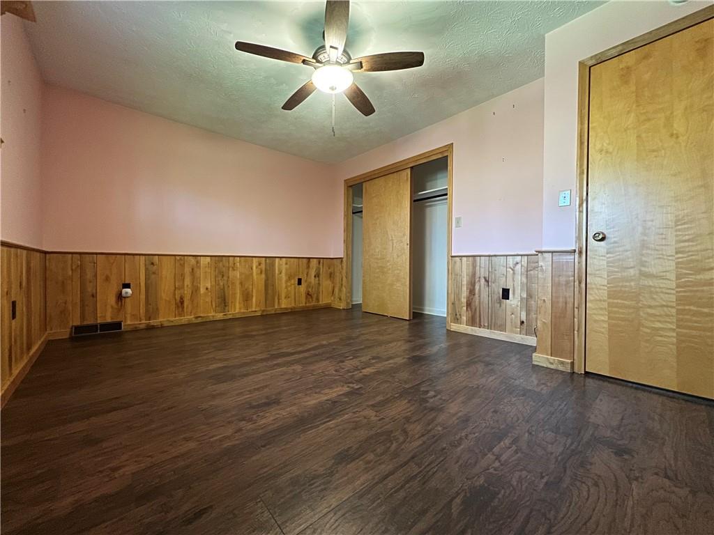 915 Quebec Road Farmington, PA 15437 - Photo 27 of 41 a view of an empty room with wooden floor