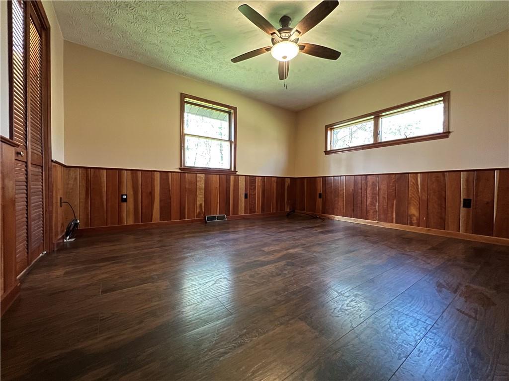 915 Quebec Road Farmington, PA 15437 - Photo 28 of 41 a view of a livingroom with wooden floor and a ceiling fan
