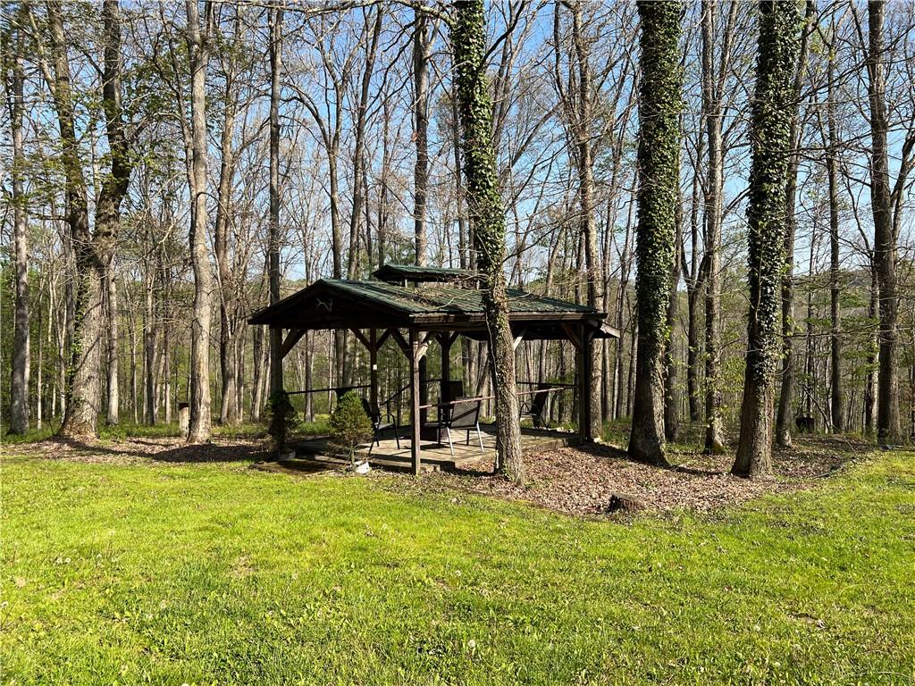 915 Quebec Road Farmington, PA 15437 - Photo 8 of 41 a view of a backyard with a table and chairs