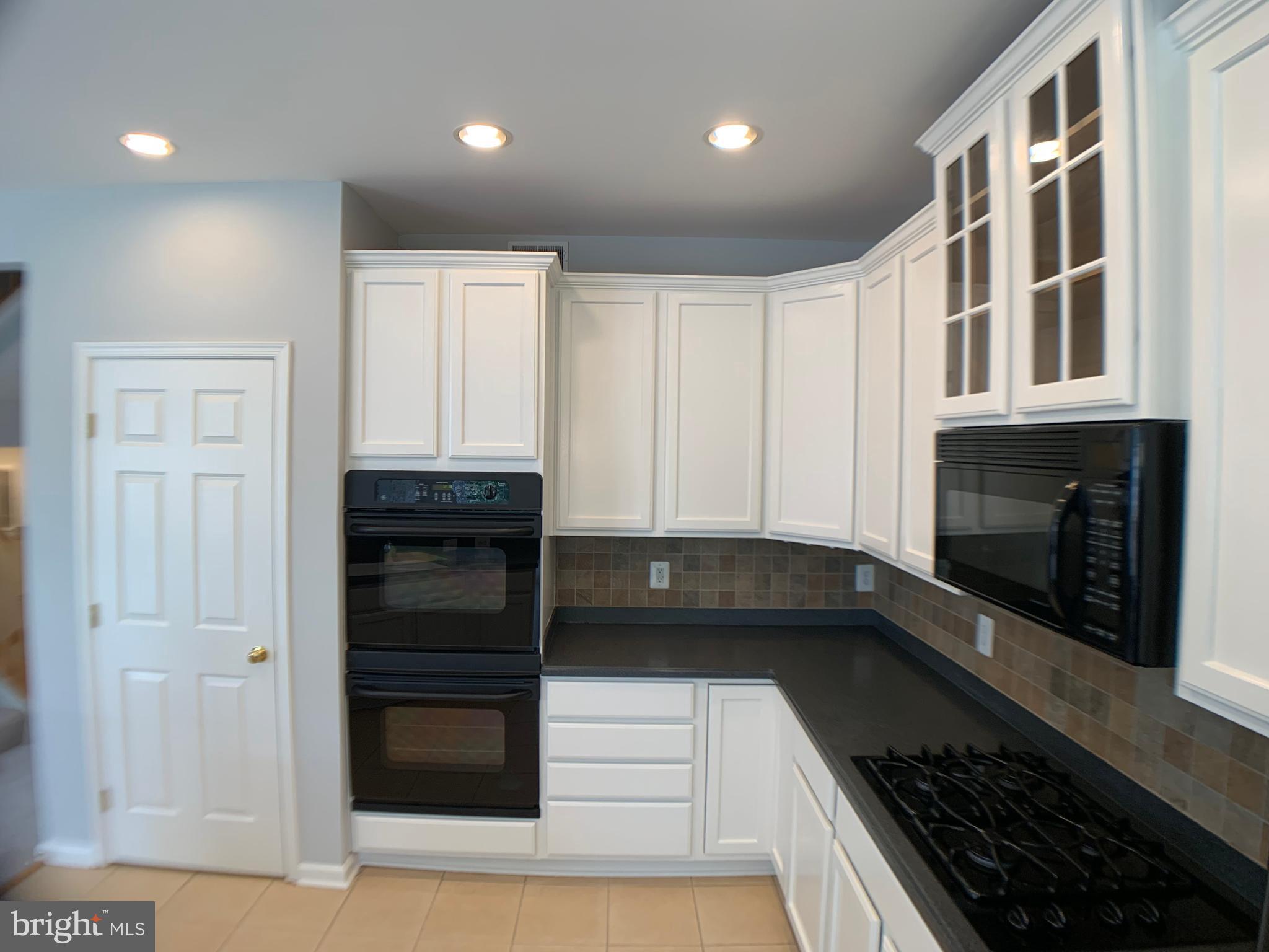 43397 Allisons Ridge Terrace Ashburn, VA 20148 - Photo 14 of 42 Tile backsplash, dbl ovens and gas cooktop