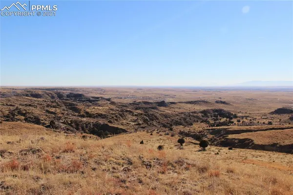 an aerial view of house with yard and mountain in the back