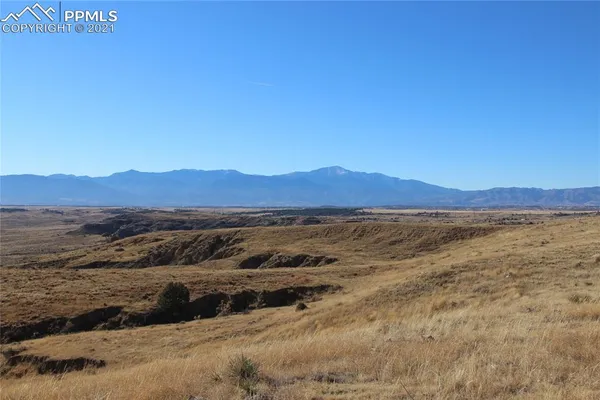 a view of mountain and an ocean beach