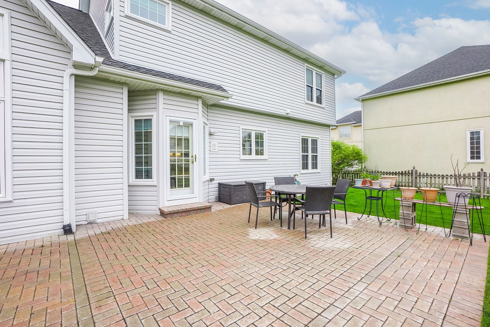 4775 Snapjack Circle Naperville, IL 60564 - Photo 48 of 55 a view of a patio with table and chairs with wooden floor and fence
