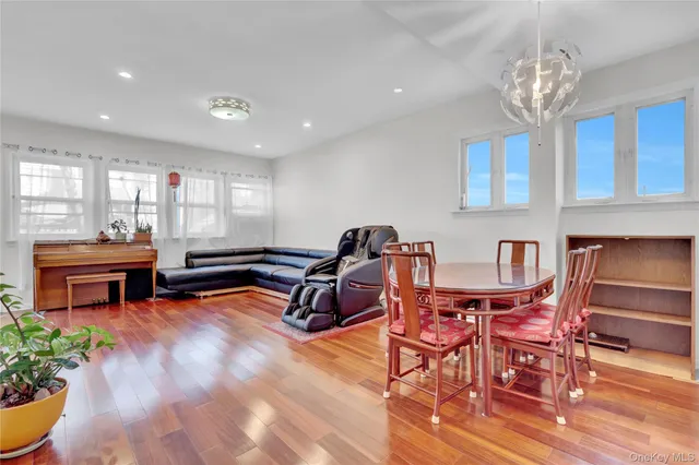 a living room with furniture a piano and a chandelier