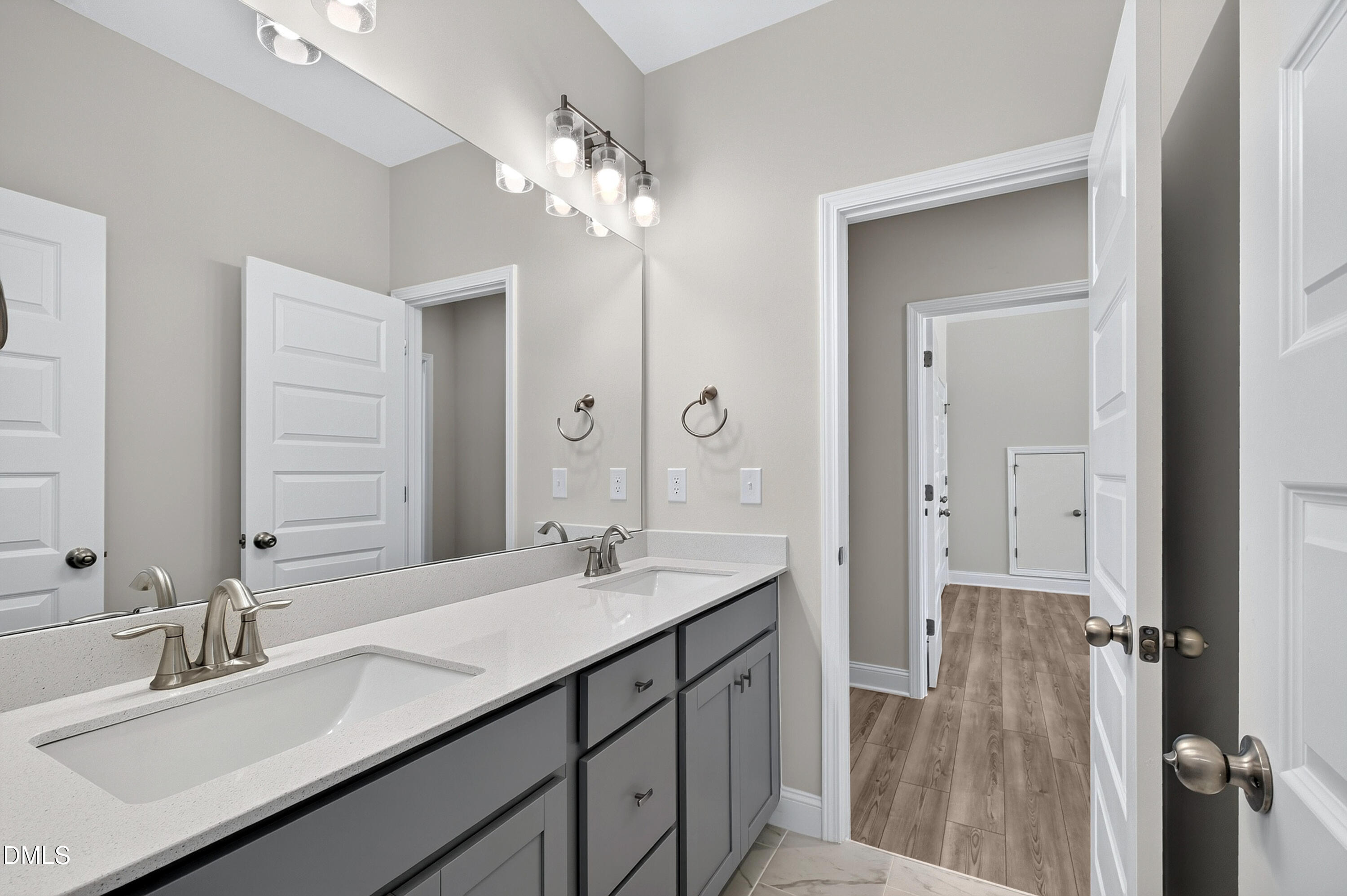 1300 Commons Ford Place Apex, NC 27539 - Photo 55 of 70 a bathroom with a sink double vanity and a mirror