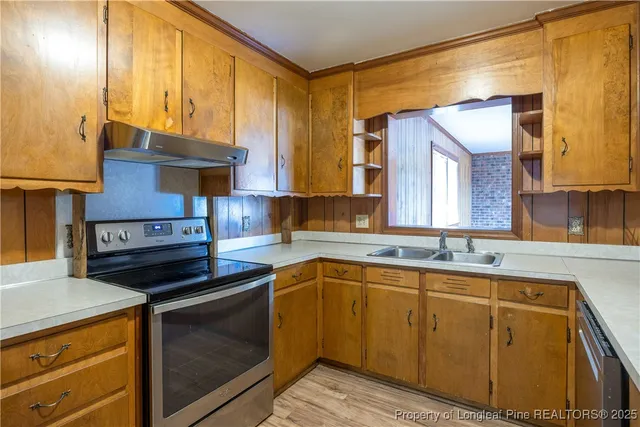 a kitchen that has a sink and a stove in it