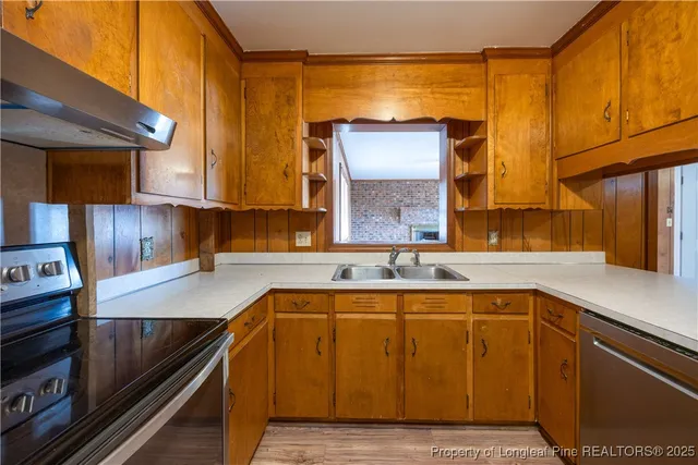 a kitchen with a sink cabinets and window