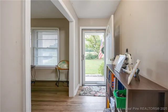 a view of workspace with wooden floor windows cabinet and wooden floor