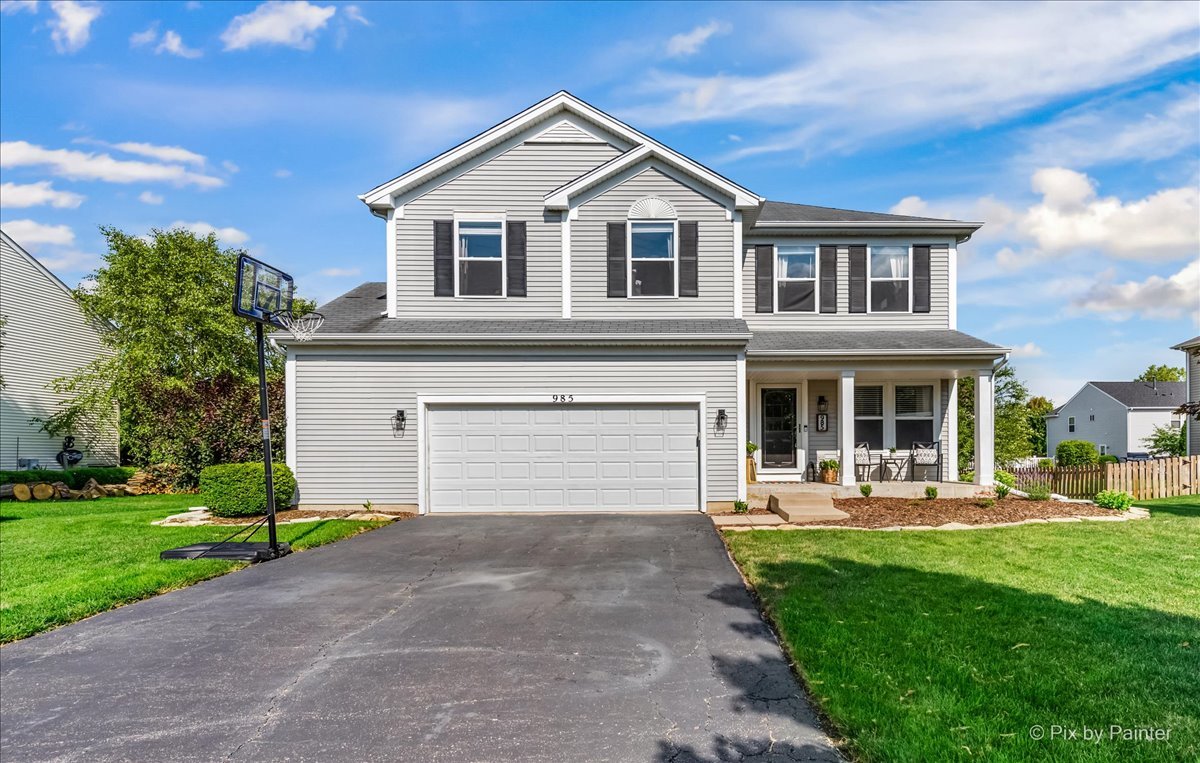985 Kendall Street Elburn, IL 60119 - Photo 1 of 32 a front view of a house with garden and porch