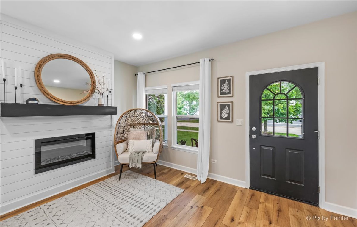 985 Kendall Street Elburn, IL 60119 - Photo 19 of 32 a living room with furniture a fireplace and a window