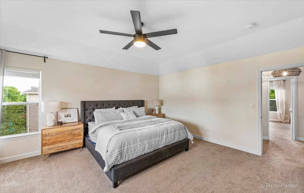 985 Kendall Street Elburn, IL 60119 - Photo 25 of 32 a bedroom with a bed and a ceiling fan