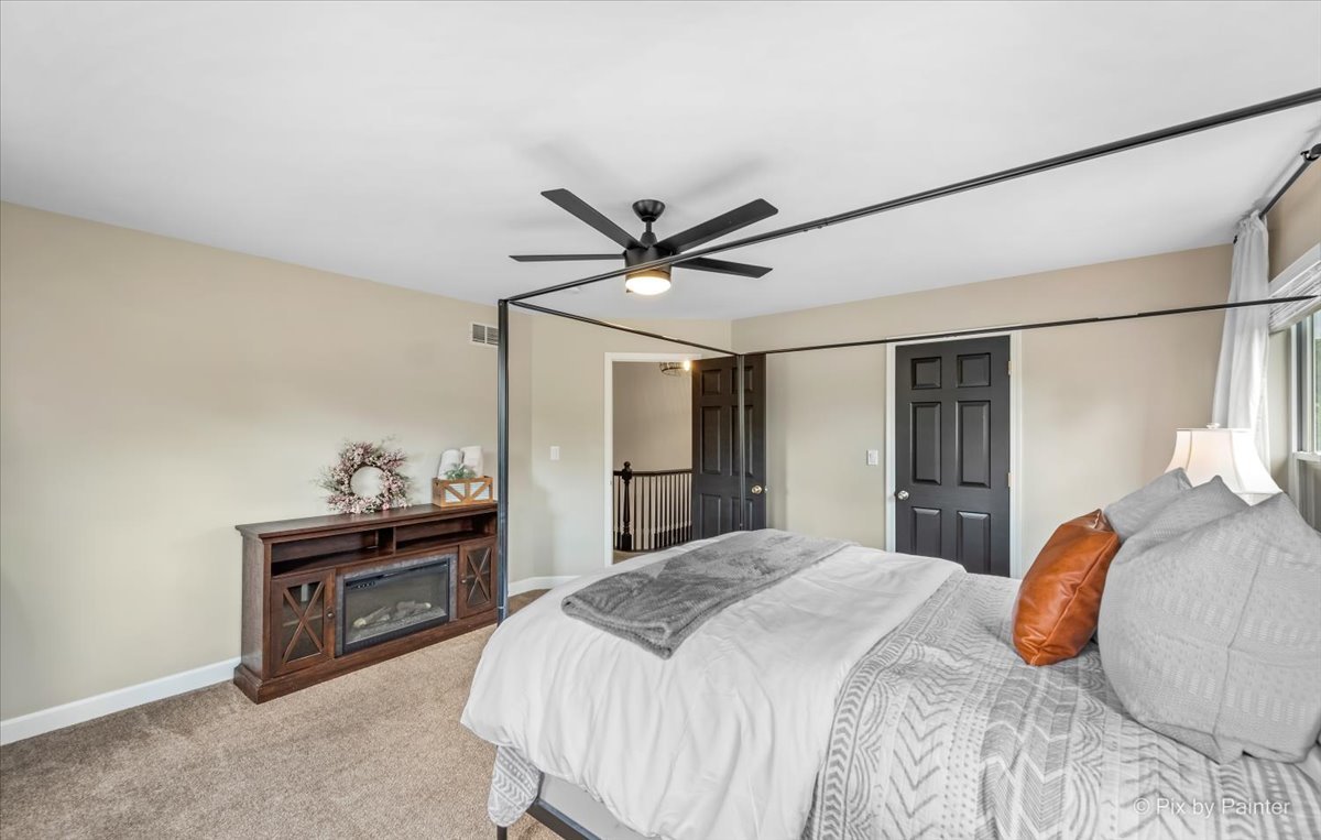 985 Kendall Street Elburn, IL 60119 - Photo 27 of 32 a bedroom with a bed and a ceiling fan