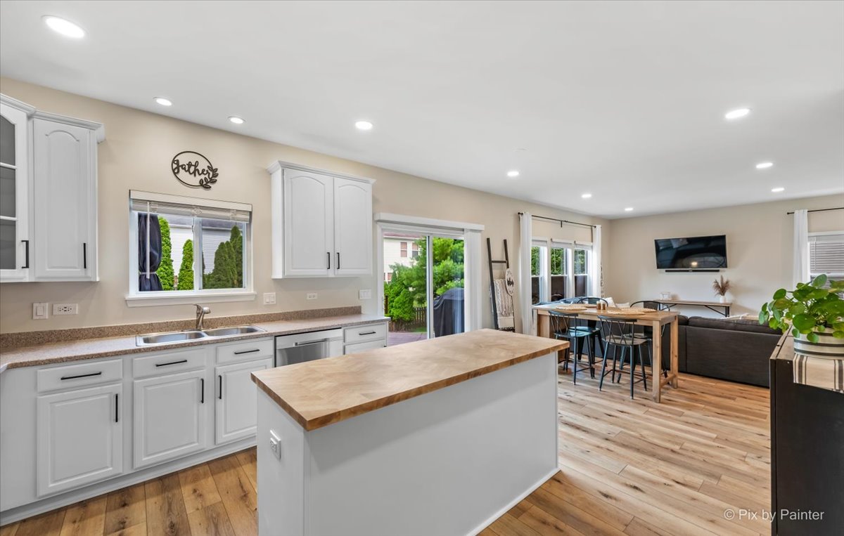 985 Kendall Street Elburn, IL 60119 - Photo 4 of 32 a large kitchen with kitchen island a sink table and chairs