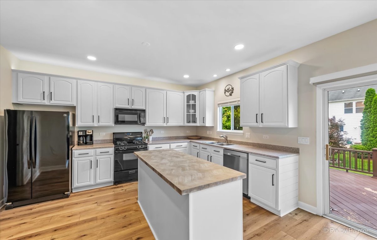 985 Kendall Street Elburn, IL 60119 - Photo 5 of 32 a kitchen with a sink stove and refrigerator