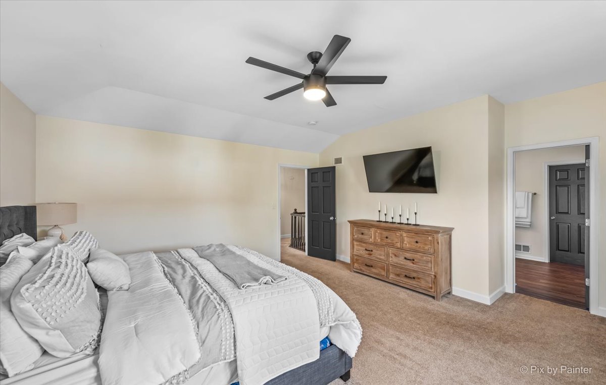985 Kendall Street Elburn, IL 60119 - Photo 9 of 32 a bedroom with a bed and a flat screen tv