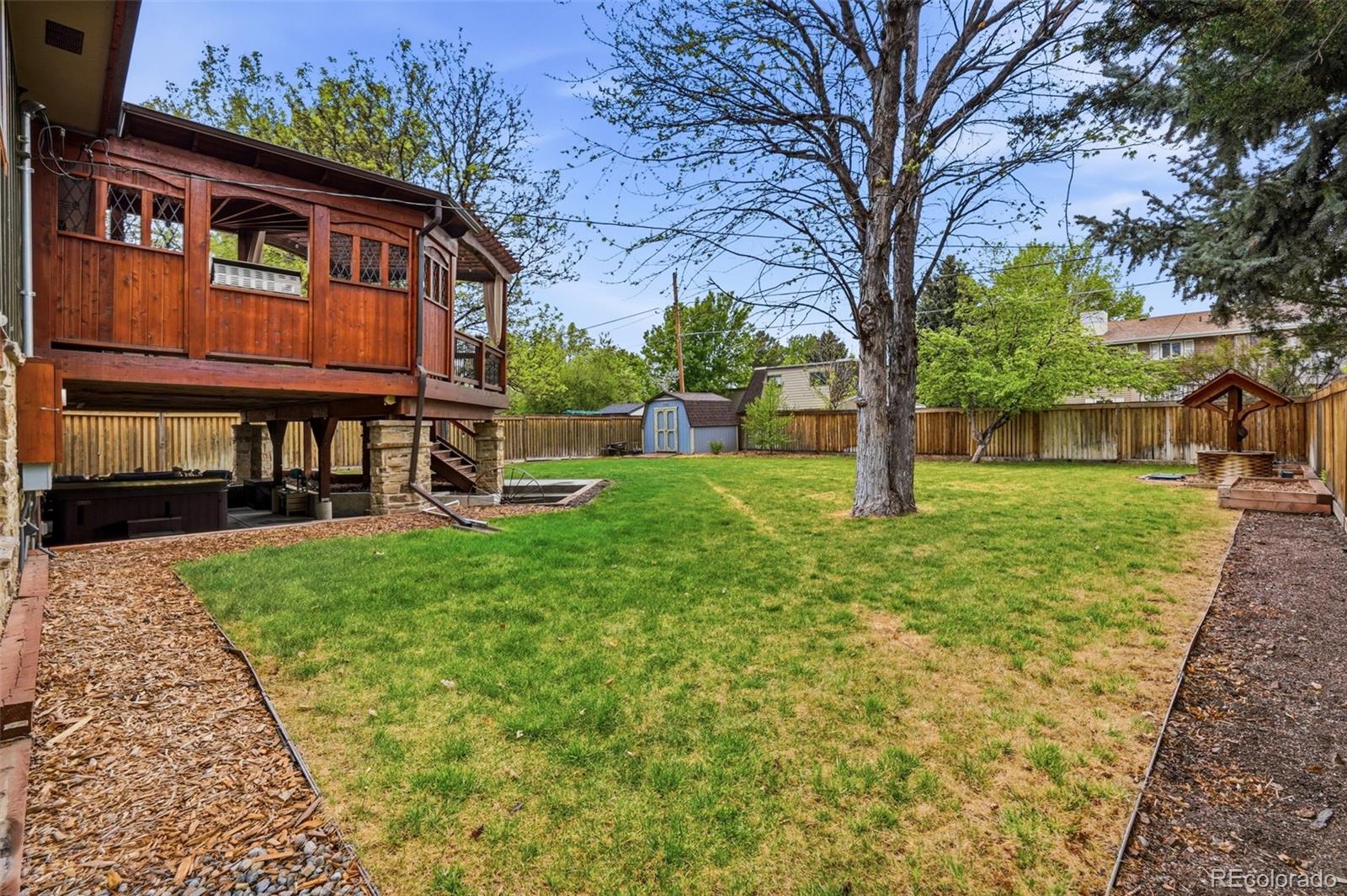 3393 Simms Street Wheat Ridge, CO 80033 - Photo 33 of 42 a front view of a house with a yard