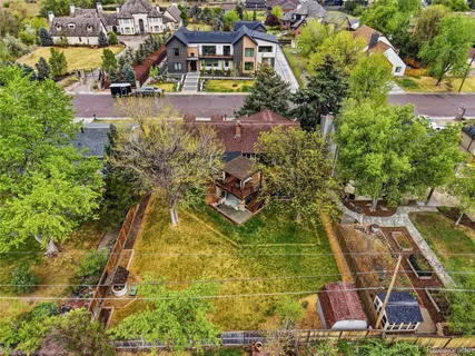 an aerial view of a house with a yard and swimming pool