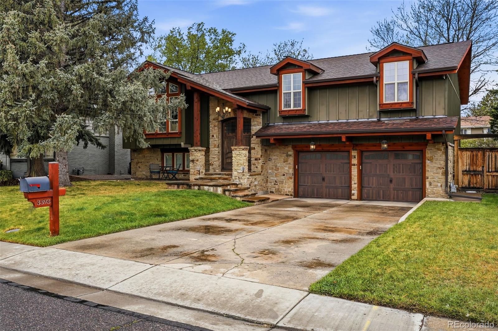 3393 Simms Street Wheat Ridge, CO 80033 - Photo 41 of 42 a front view of a house with a yard and garage