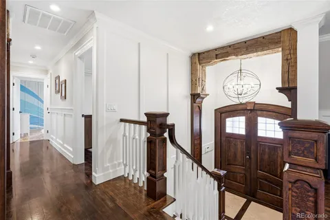 a view of a hallway with wooden floor and entryway