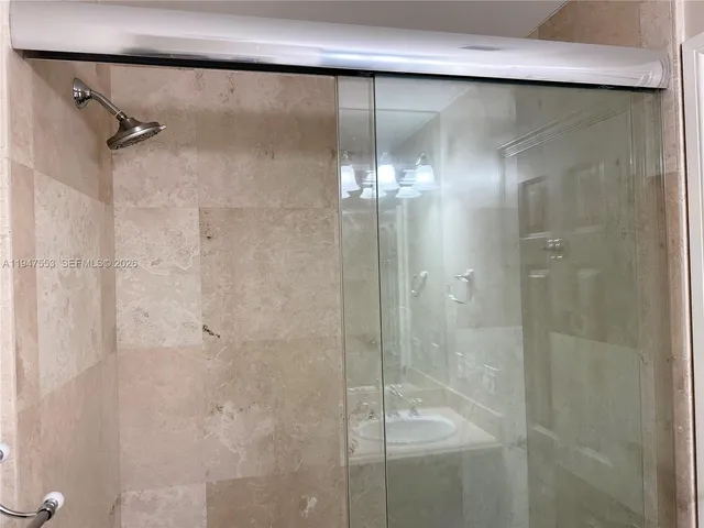 a bathroom with a glass shower door