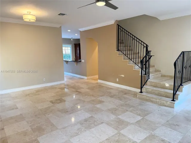 a view of an empty room with stairs