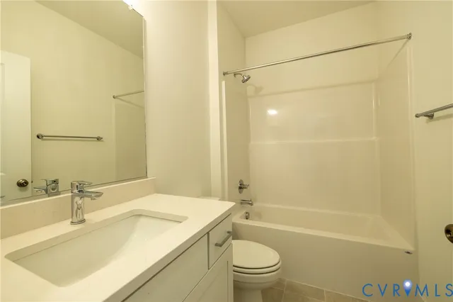 a bathroom with a sink toilet vanity and shower