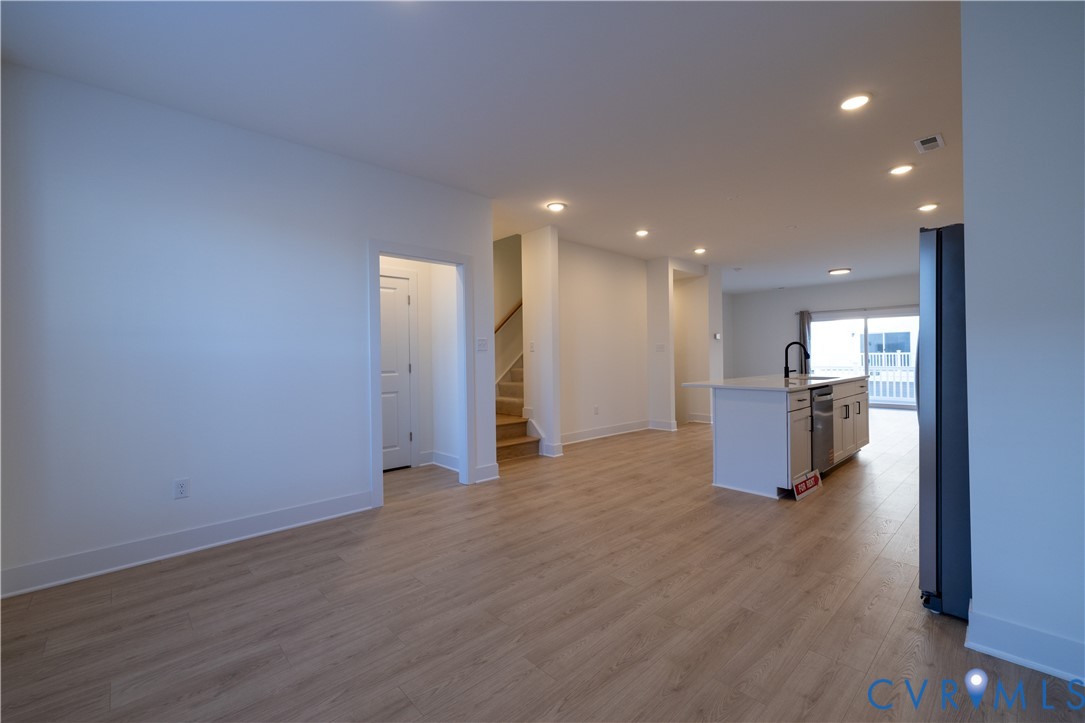 15309 Sunray Alley Chesterfield, VA 23832 - Photo 28 of 50 a view of a big room with wooden floor and a kitchen