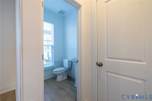 a white toilet sitting next to a bathroom sink