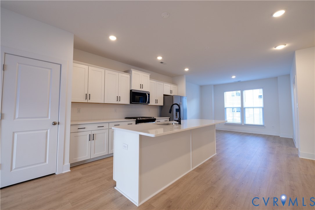 15309 Sunray Alley Chesterfield, VA 23832 - Photo 37 of 50 a kitchen with stainless steel appliances a white stove top oven sink and cabinets