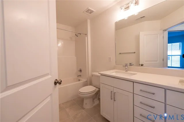 a bathroom with a granite countertop sink a toilet and a bathtub