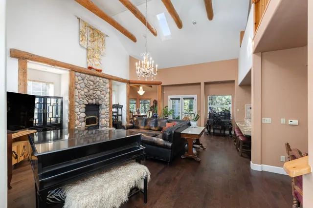 a living room with furniture a flat screen tv and a large window