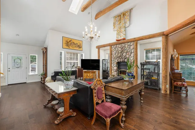 a view of a room with wooden floor and a floor to ceiling window