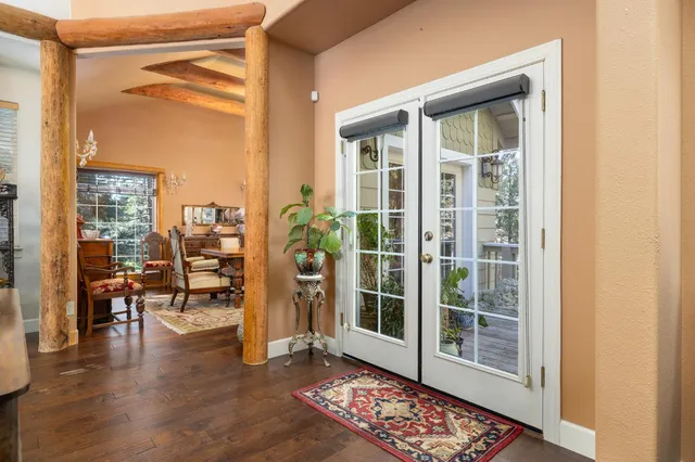 a dining room with furniture and a floor to ceiling window