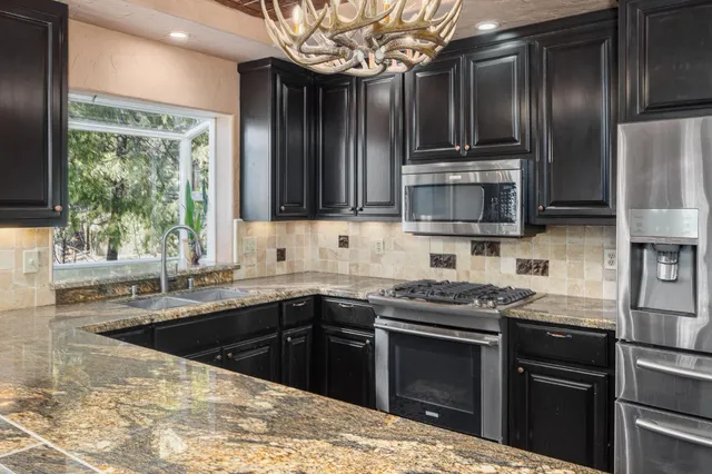 a view of a refrigerator in kitchen and wooden floor