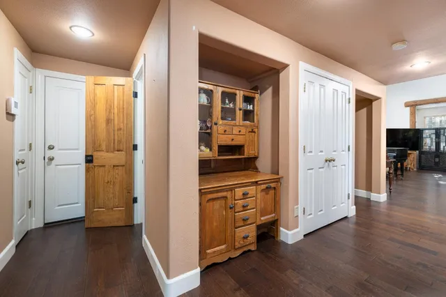 a spacious bedroom with a bed a chandelier and a window