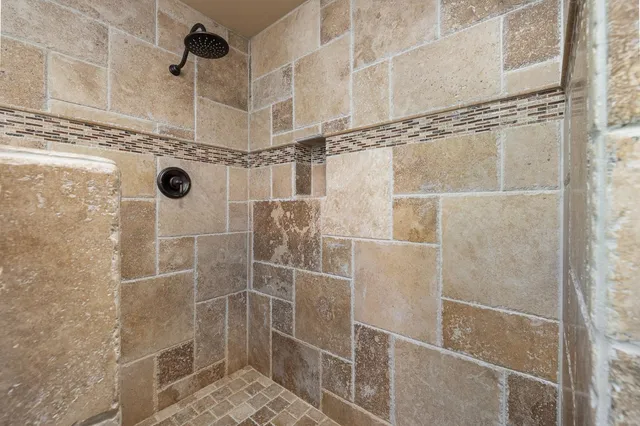 a living room with furniture a ceiling fan a flat screen tv and a window