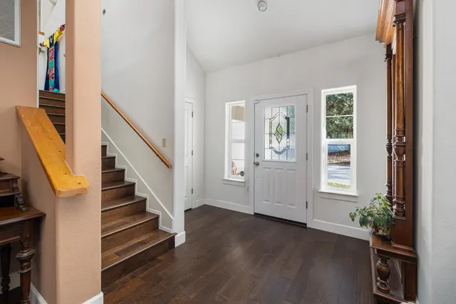 a living room with furniture a flat screen tv and a large window