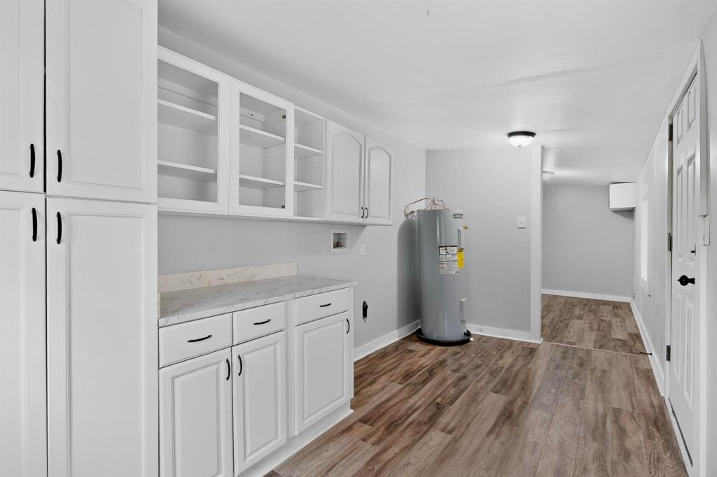 313 Farm To Market 316 Eustace, TX 75124 - Photo 19 of 33 a view of a kitchen with refrigerator and wooden floor