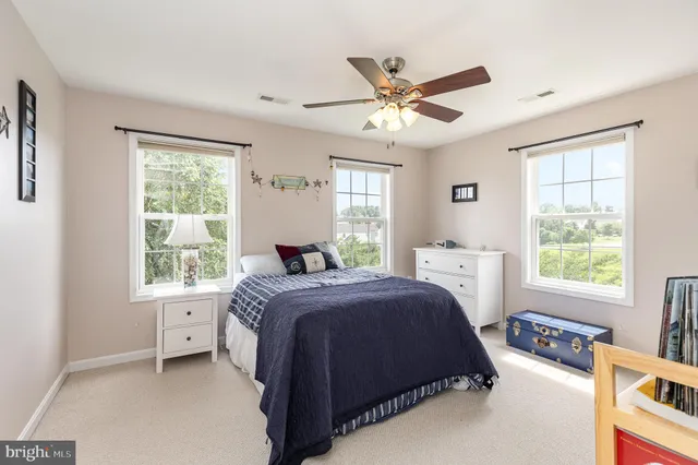 a spacious bedroom with a large bed and a window