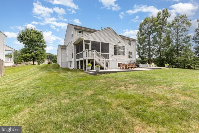 a view of a house with a yard and sitting area