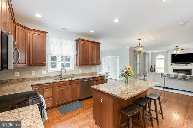 a kitchen with granite countertop a sink and cabinets