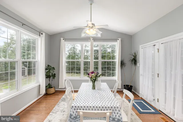 a room with wooden floor and large windows
