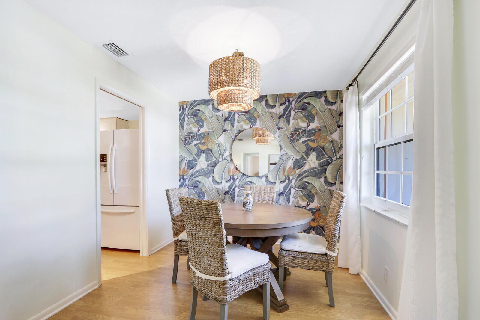 8574 Southeast Seagrape Way Hobe Sound, FL 33455 - Photo 13 of 38 a view of a dining room with furniture and wooden floor