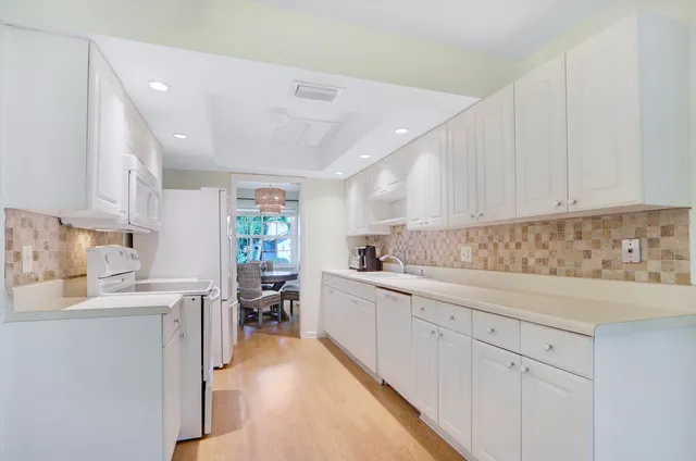 a kitchen with a sink window and cabinets